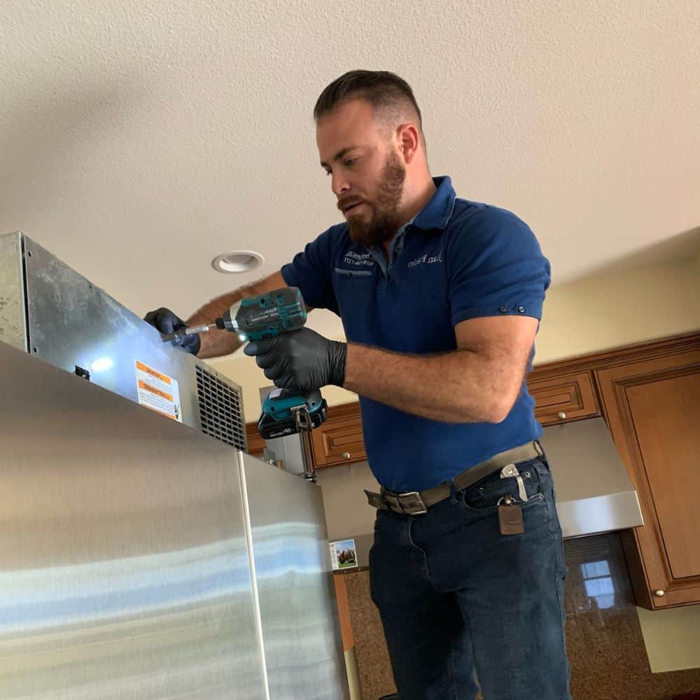 A technician carries out a San Diego appliance repair.